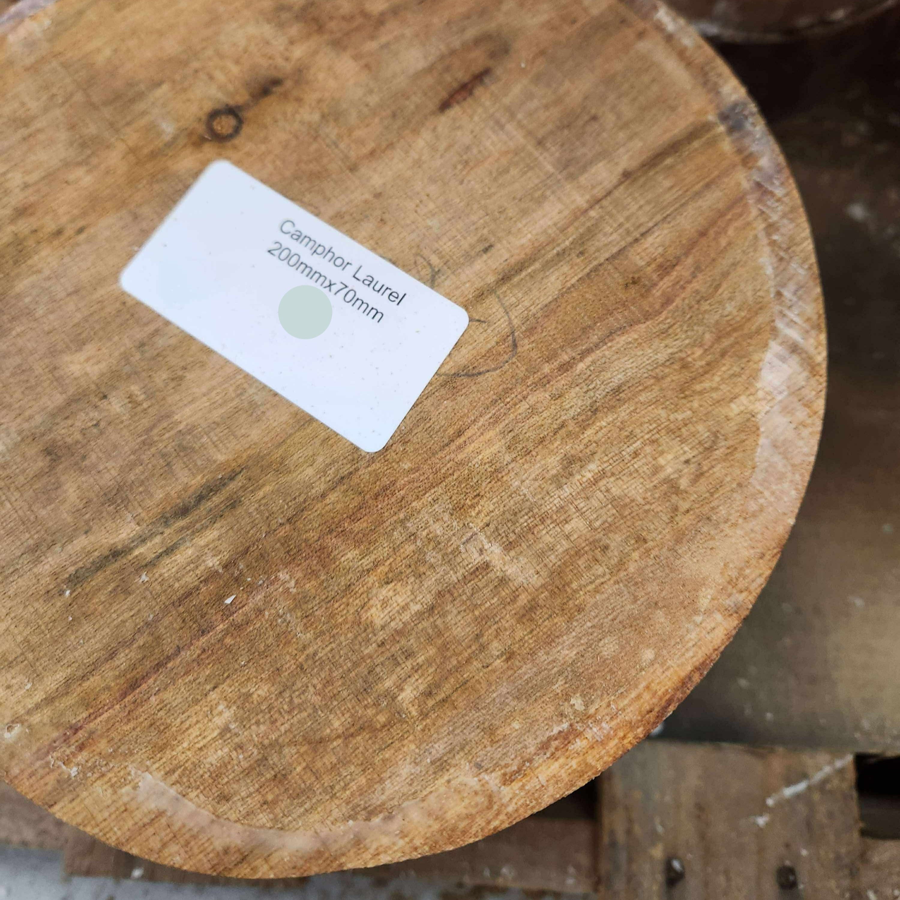 Wooden log with a label on a wooden surface